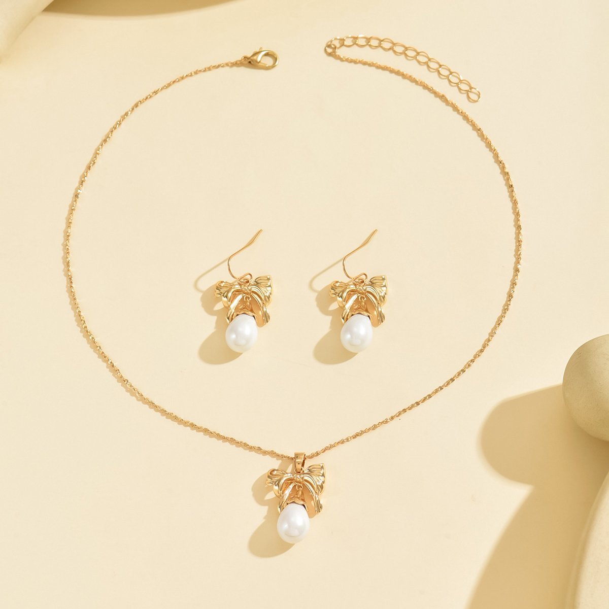 Elegant Gold-Toned Bow & Pearl Jewelry Set - Necklace & Earrings