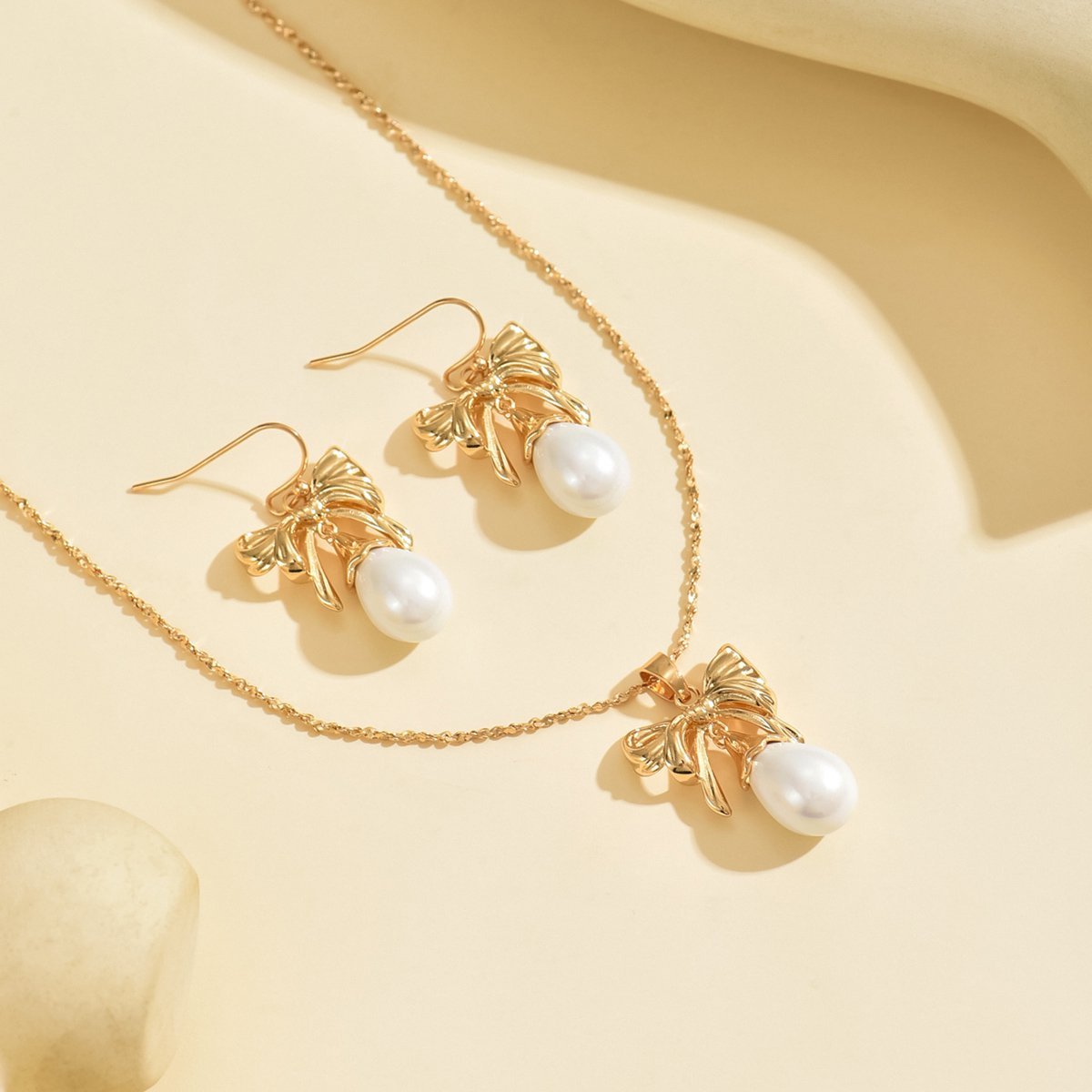 Elegant Gold-Toned Bow & Pearl Jewelry Set - Necklace & Earrings